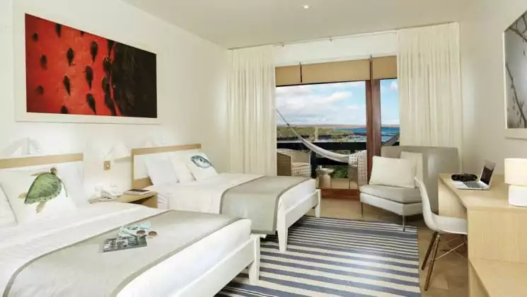 Suite with full-size beds at Finch Bay Eco Hotel