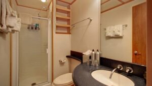 Admiral stateroom bathroom with vanity, toilet and shower aboard the Safari Quest san juan islands small ship