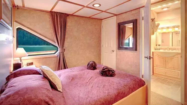 Pathfinder Stateroom with fixed queen bed aboard Safari Quest. Photo by: UnCruise