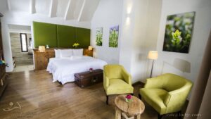 Junior Suite with large bed and sitting area with small table and two chairs at Colca Lodge in Peru