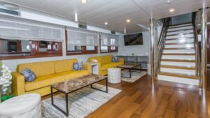 Adriatic Sun Lounge with yellow couch and stairway.
