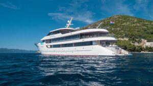 Stern of Avangard cruising near land in the Mediterranean.