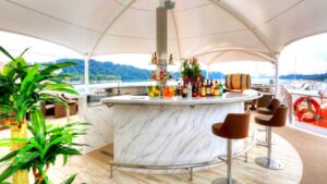 Sun deck bar outside under canopy aboard Coral Adventurer.