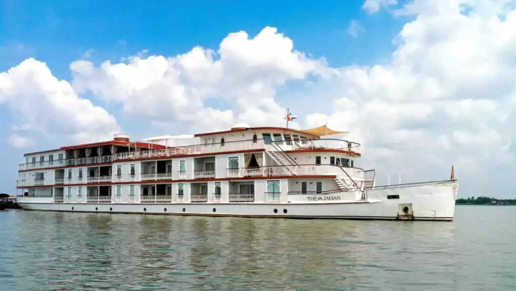 Jahan exterior anchored in Southeast Asia in calm waters and blue skys with white fluffy clouds as a backdrop.