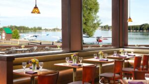 Tables are positioned in the dining room for an ideal view of the water and float planes taking off, at the Lakefront Anchorage lodge in Alaska