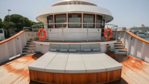 Sun Deck with long chaise daybeds and bright teak decking in front of captain's Bridge aboard Nautilus Croatia & Mediterranean deluxe small yacht.