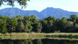 A scene of blue mountains and a green lagoon in Panama.