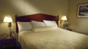 A queen bed in a room at the historic Baranof Hotel in Juneau Alaska