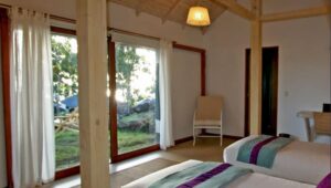 an interior room with a large window and striped rug at the Altiplanico hotel