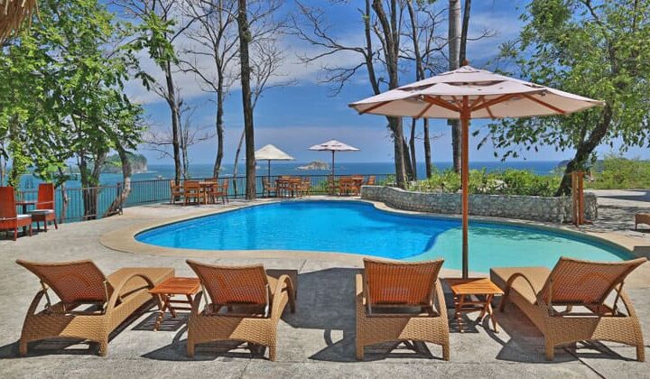 The pool and lounge chairs at Arenas Del Mar, a luxury lodge in Costa Rica.