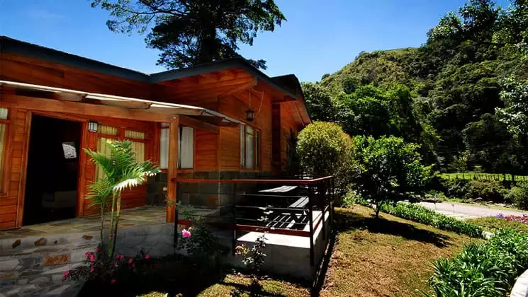 casa grande bambito exterior on a sunny day with lush forest behind it
