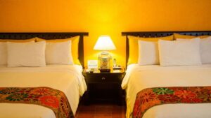 room at clarion copan hotel guatemala with two beds and a nightstand with a lamp in between them