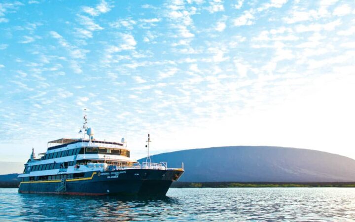 Full exterior of starboard side and bow of National Geographic Islander expedition ship in Galapagos Islands