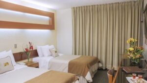 A room with two twin beds, artwork, and drapes at Sonesta Posada Del Inca Arequipa, a luxury boutique hotel