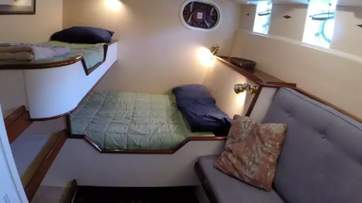 Cabin 2 with a hanging locker and built-in seating aboard the Westward.