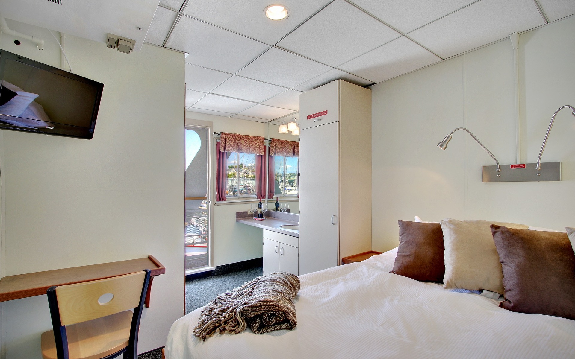 Trailblazer Cabin with desk, view window, sink and fixed queen bed aboard Wilderness Explorer