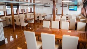 Fantazija dining room with with tables, chairs and windows.