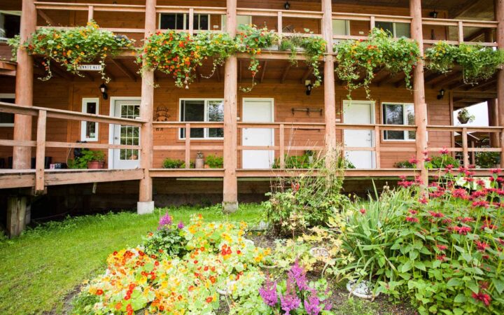 Annie Mae Lodge outside view of deck and garden with lots of flowers.