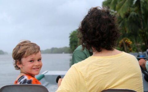 father and son on boat on costa rica family adventure land tour
