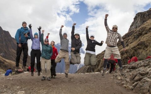 group shot with everyone jumping on inca trail trek land tour in peru