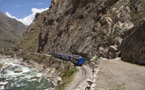train beside river in mountains on inca trail trek land tour in peru