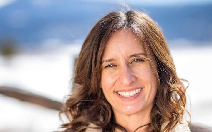 adventuresmith explorations chief financial officer lisa exley-smith smiling with bright snow behind her