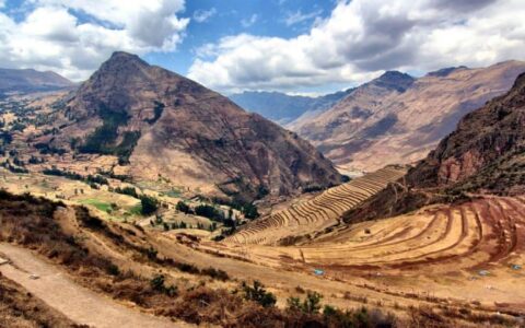 huge clouds leave shadows on the epic mountain landscape of peru on machu picchu explorer land tour