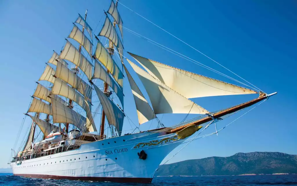 The Sea Cloud under full sail seen from in front of the bow