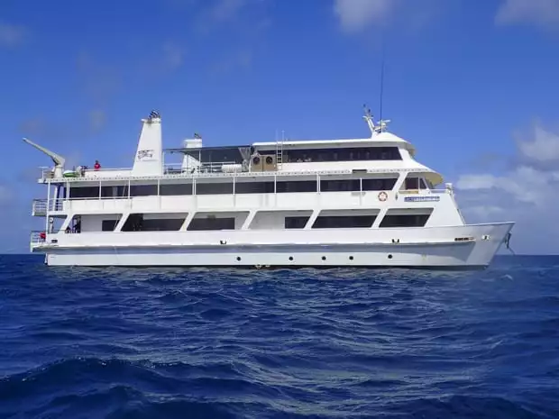 An image of the Coral Expedition II in Australia with three decks and white hull.