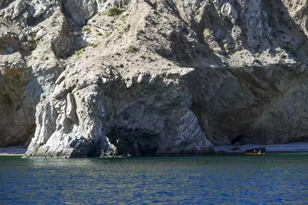 Baja traveler kayaking the coastal line of a Baja island.