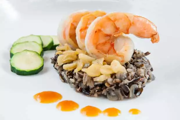 Prawn dish with wild rice and zucchini.