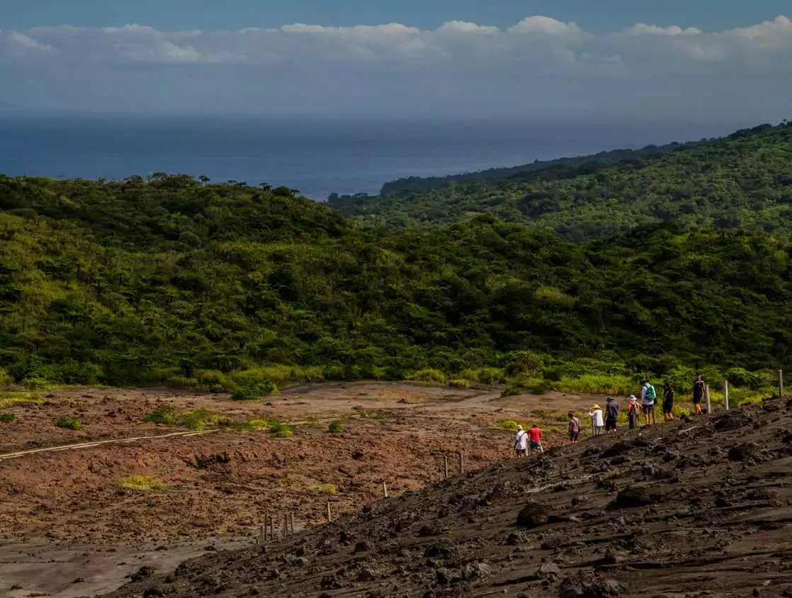 Guests from a small ship cruise hiking on an island in the south pacific. 