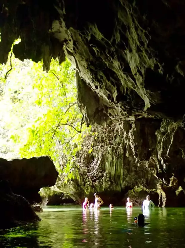 Guests on a small ship cruise exploring caves in Indonesia. 
