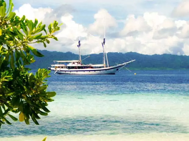 Small ship cruising Ombak Putih sailing in Indonesia. 