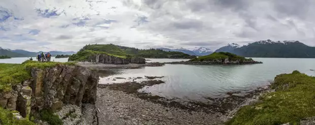 People on a coastal hike with the islands and shoreline of Katmai Alaska. 