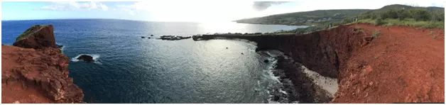 Panoramic photo with red cliffs along the coastline