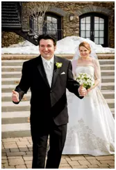The honeymooners smiling at their wedding