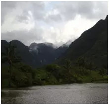 Green hillside and coast of Hawaii with large green mountains