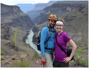 The Hawaii honeymooners hiking by a gorge with a river