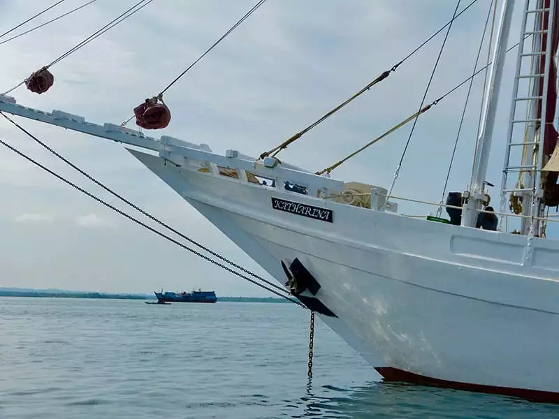 a close up photo of the white katharina small wooden traditional indonesia ship