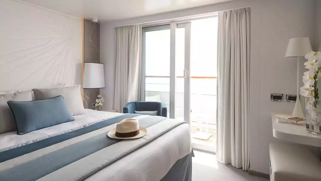 Deluxe Suite with king bed aboard Le Lyrial. Photo by: Nicolaus Matheus/Ponant