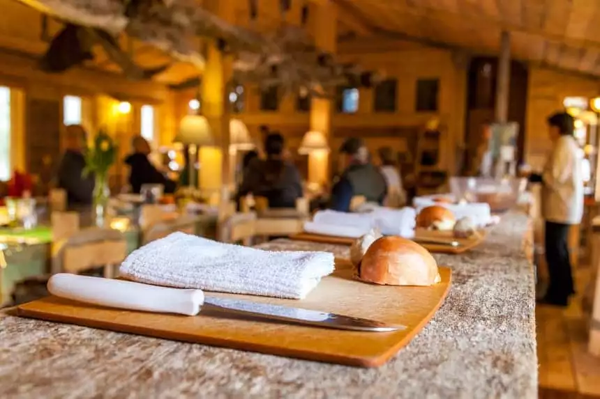 A cutting board with knifes and vegetables sit in a row for the cooking class avalable at Winterlake Lodge in Alaska