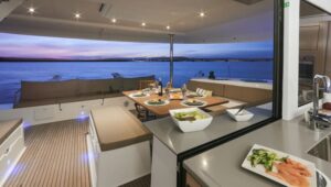 Al fresco dining aboard Belize charter ship Nowhere, with grey counters & upholstered seating.