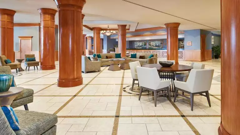 The lobby of the Hilton Downtown Anchorage, gloccy wodden columns are featured between seating areas.