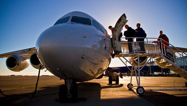 Guests board a plane from the tarmac to start a seamless Chile vacation