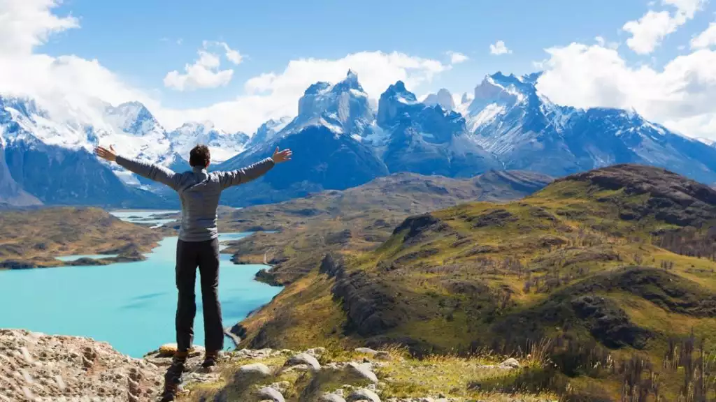 Man at mirador condor enjoying hiking and view of cuernos del paine in torres del paine national park, patagonia, chile