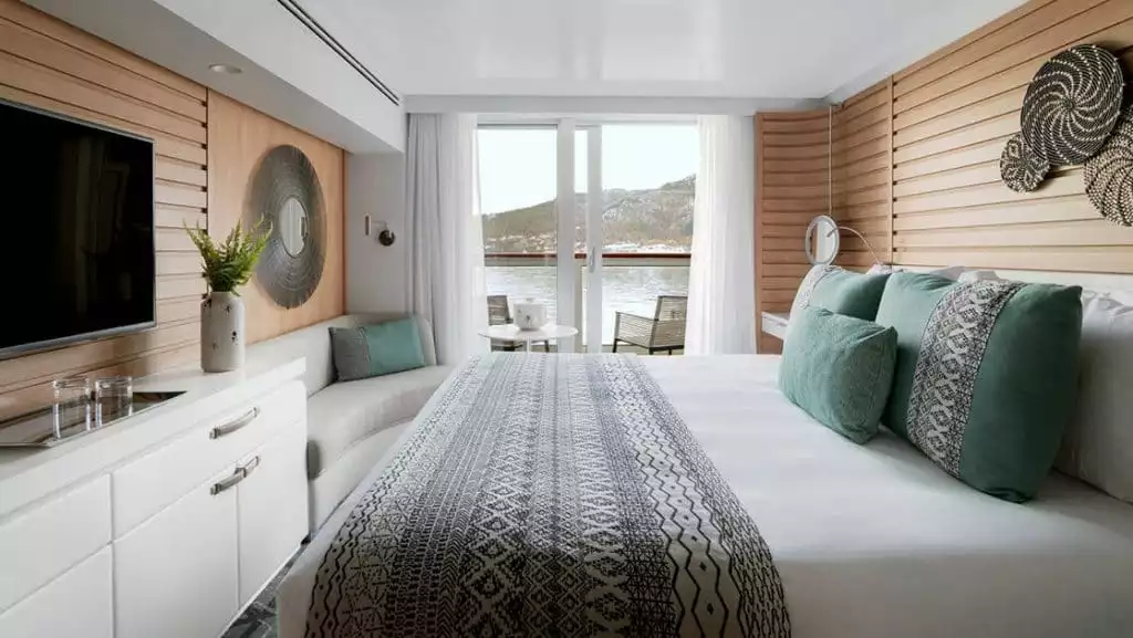 Prestige Stateroom - Decks 4, 5 & 6 with king bed aboard Le Bellot. Photo by: Francois Lefebvre/Ponant