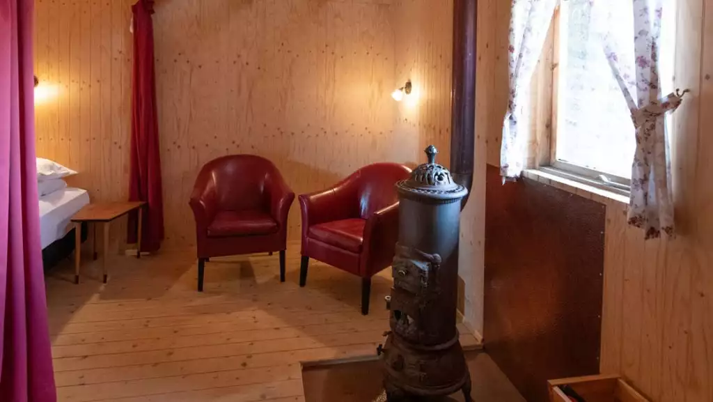 Downstairs double bed and seating area in traditional turf guesthouse