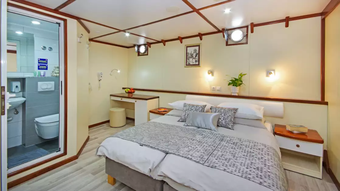 Lower Deck Standard cabin showing double bed configuration and two small portholes on the M/S Aurora Croatia yacht