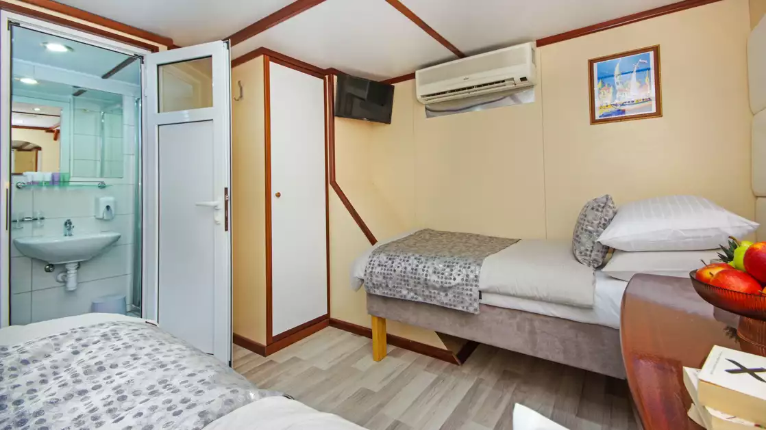 Main Deck Twin cabin showing two beds and a peek inside the bathroom on the M/S Aurora Croatia yacht